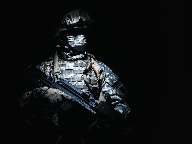 infantry with machine gun standing in darkness